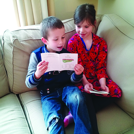 Boy reading Little Stories for Little Folks, Catholic phonics readers.