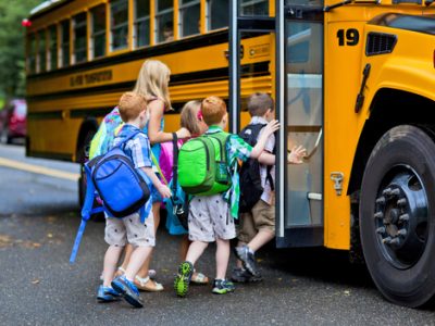 A,Group,Of,Young,Children,Getting,On,The,Schoolbus