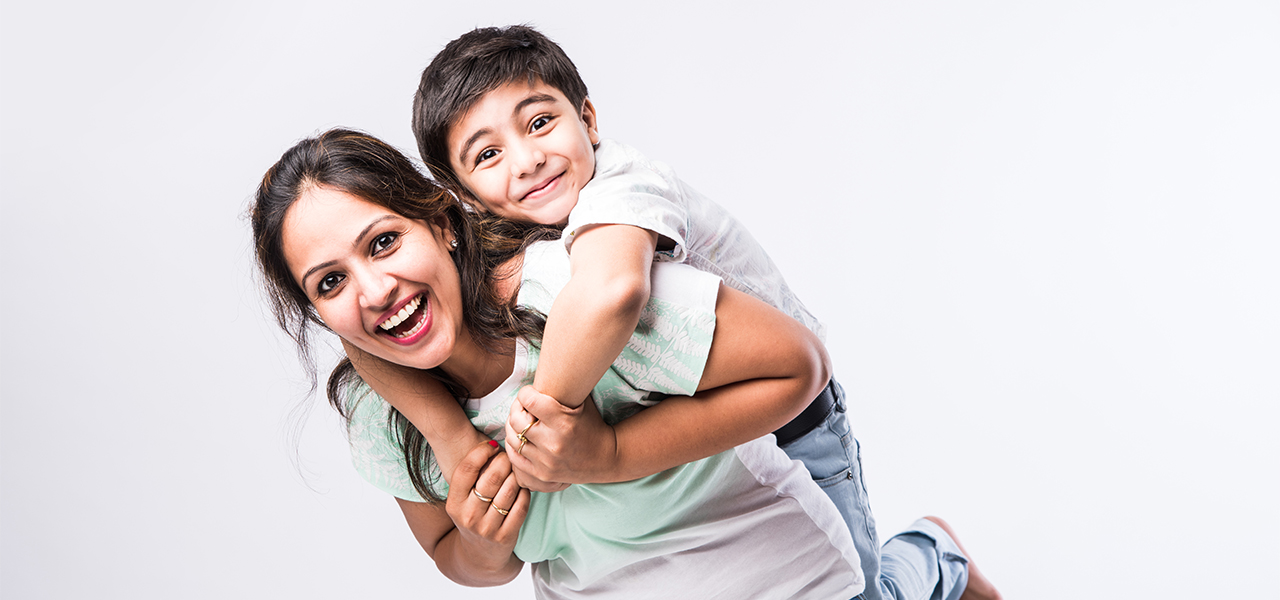 Joyful mom and young son laughing