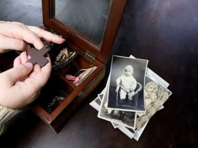 Female,Hands,Sorting,Dear,To,Heart,Memorabilia,In,Old,Wooden