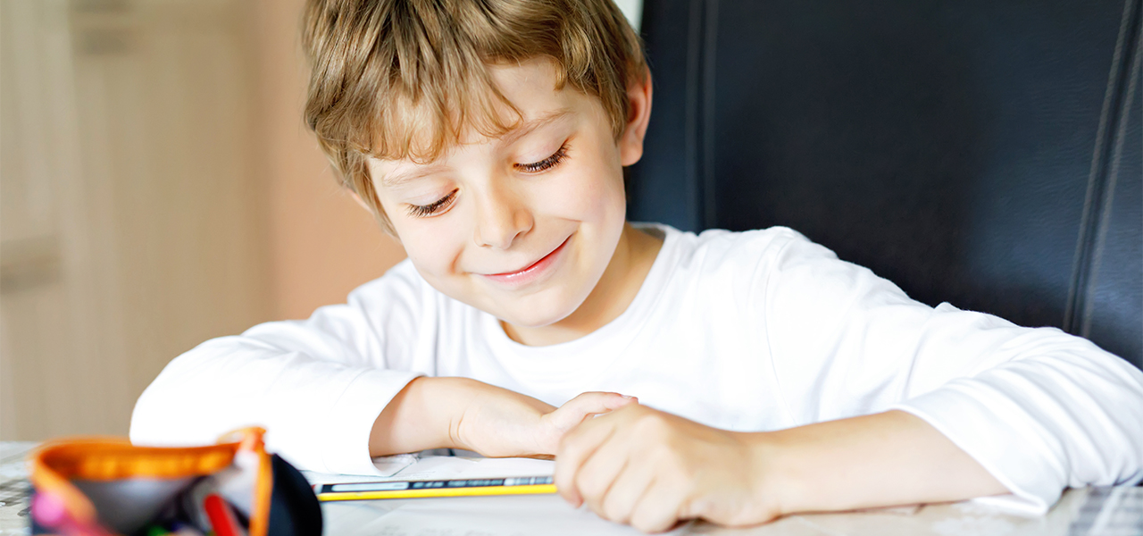 Boy at home completing schoolwork