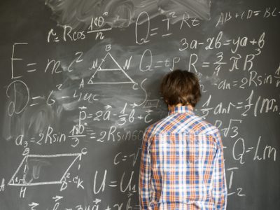 Teenageer,Boy,Having,Trouble,With,Complicated,Math,Formulas,On,Black